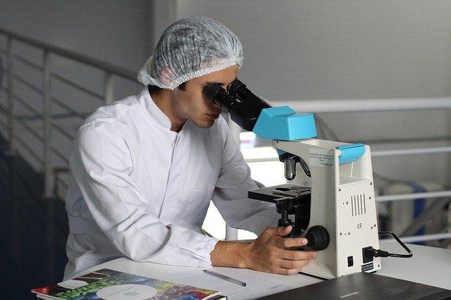 scientist using microscope